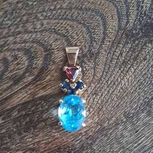 Elegant Gold Pendant with Blue and Red Gemstones